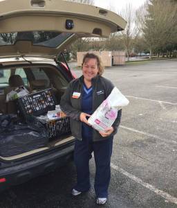 Jennifer Beach with VCA Redmond Animal Hospital drops off her team&rsquo;s donation – including pet food, which is always in demand at Hopelink food banks. Courtesy photo