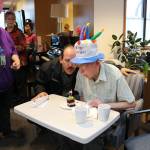 George Mosebar (right) and his son David blow out candles on a piece of cake at George&rsquo;s 100th birthday celebration at the Redmond Senior Center. Samantha Pak, Redmond Reporter.