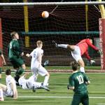 Redmond High goalkeeper Pedro Menchaca spins around after punching a shot away during the Mustangs&rsquo; 3-0 boys soccer victory over Woodinville High on Tuesday night. Andy Nystrom,Redmond Reporter