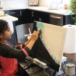 Ira Ganjikunta, 6, works on a painting at her Redmond home. CATHERINE KRUMMEY/Kirkland Reporter