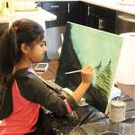 Ira Ganjikunta, 6, works on a painting at her Redmond home. CATHERINE KRUMMEY/Kirkland Reporter