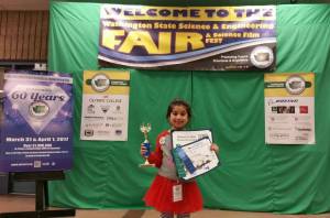 Horace Mann Elementary first-grader Aarya Kulkarni displays her awards at the 60th Washington State Science and Engineering Fair (WSSEF) at Bremerton High.