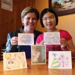 From left, Jenny and Megan Lisk with cards designed by Megan to raise money for brain cancer research. Samantha Pak, Redmond Reporter