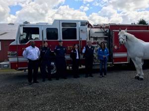 Firefighters pose with Victor, the horse being sponsored by the Firefighter Benevolent Fund donation. Courtesy photo