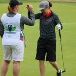 Mandy Demerse, right, celebrates with her caddie Michelle Cundarie after putting out on hole 18 this morning at the 2017 Special Olympics North America Golf Championship at Willows Run Golf Complex in Redmond. Andy Nystrom, Redmond Reporter