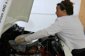 Sharon Crosetto cleans the V-8 engine she installed in the AM General 1982 jeep she and her daughter use at Moonie Icy Tunes. Moonie was started around nine years ago and moved to Redmond last winter. Aaron Kunkler/Redmond Reporter