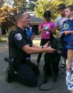 Redmond Police Department K9 Officer Dan Smith and partner visit with kids at National Night Out on Tuesday. Courtesy photo