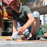 Netherlands-based artist Remko Van Schaik uses paint to create his art last Saturday at the Chalk Fest. Aaron Kunkler/Redmond Reporter
