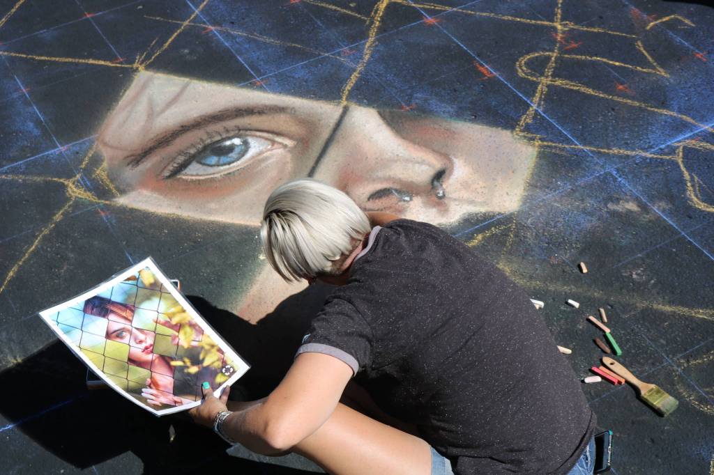 Artist Tonya Youngberg works on her piece last Saturday at the Pacific NW Chalk Fest in Redmond. Aaron Kunkler/Redmond Reporter