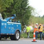 Workers evaluate the scene on West Lake Sammamish Parkway on Friday morning. A tanker and trailer slid off the offramp. Andy Nystrom, Redmond Reporter