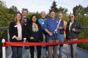 From left to right at the Redmond Central Connector Phase II opening: Redmond City Council members Angela Birney, Hank Margeson, Tanika Padhye, John Stilin, Mayor John Marchione, and city council members Byron Shutz and Hank Myers. Not pictured: City council member David Carson. At right, an artist&rsquo;s rendering of a portion of the connector. Courtesy photo and graphic