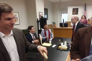 Judge Veronica Alicea-Galván&rsquo;s courtroom just after hearing arguments on the I-27 lawsuit on Friday. From left to right: Mark Cooke of the ACLU-WA; State Rep. Drew Stokesbary, serving as counsel to the defendants; Bothell City Council member and I-27 organizer Joshua Freed; Jeff Slayton, counsel from the Seattle City Attorney&rsquo;s Office; court staff; and the brown-coated shoulder of Dr. Bob Wood, former director of the HIV/AIDS Program at Public Health Seattle/King County. Photo by Casey Jaywork