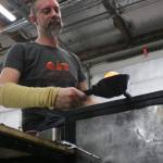 Brad Stearns works glass on the end of a pole into a ball to be shaped into a pumpkin. Aaron Kunkler/Redmond Reporter