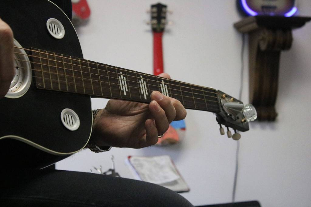 Dave Head, a music instructor at The Music Haven, plays one of his many guitars last Friday. Aaron Kunkler/Redmond Reporter