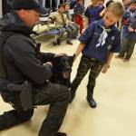 Redmond Police Departments K-9 unit, featuring Remy and officer Dan Smith, recently visited local Cub Scout Pack 557 at their meeting at Einstein Elementary to give a demonstration of police work. Pictured with Remy and Smith is Cub Scout Alexander Clum (front). Courtesy photo
