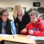 Stella Schola Middle School students Karis Jin, left, and Nicholas Coy visit with 48th Legislative District Sen. Patty Kuderer on Nov. 20 at the Redmond school. Courtesy of Linda Woo, Washington Education Association