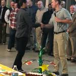 Redmond High football coach Jason Rimkus greets player Nikhil Jatekar at a banquet on Nov. 30 in the Redmond High cafe. Rimkus, who resigned at the end of the season, was presented with a framed picture of small photos of all the players. Courtesy photo