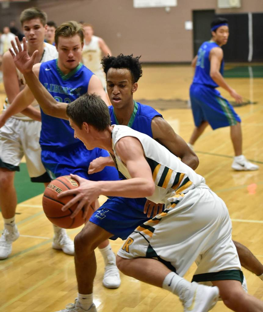 Liberty players try to stop Redmonds Maclain Forseth. Courtesy of Marc La Pierre Photography http://marclapierre.photodeck.com