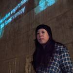 Shin Yu Pai stands below part of her poem heyday, which was screened at Redmond Lights in December. Courtesy of James McDaniel