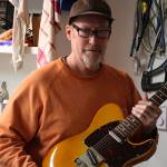 Andy Hogg, owner of Hogg Guitar Shop, holds his custom-made guitar in his shop. Aaron Kunkler/Redmond Reporter