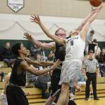 Overlake senior Tellier Lundquist, middle left, and Bear Creek junior Trevor McRae, right, go up for a rebound. Courtesy of Cindy McCahill