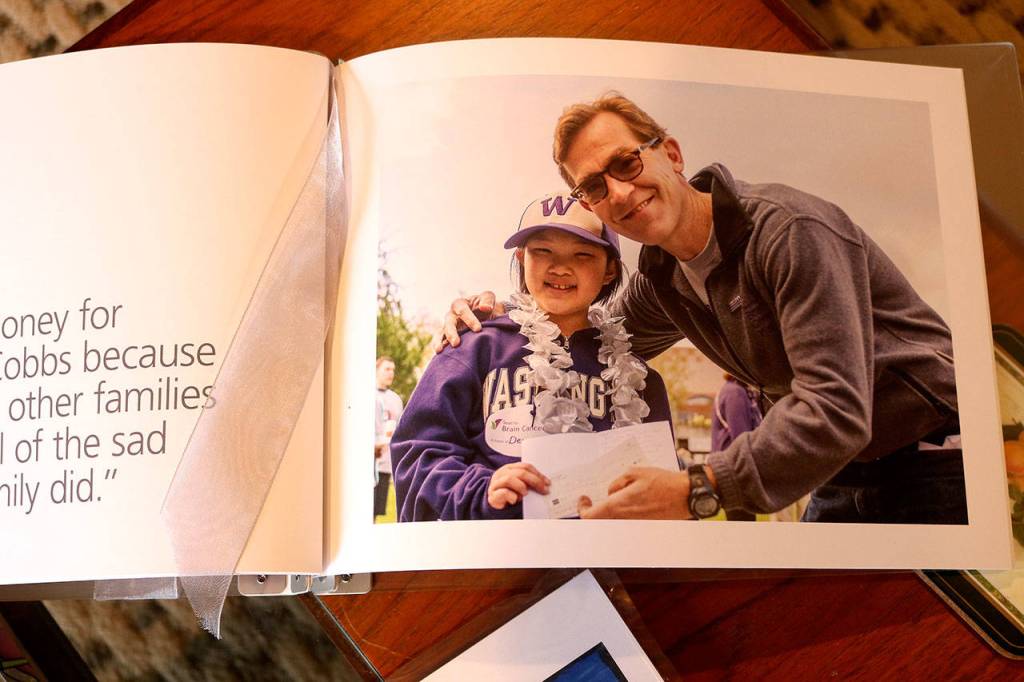 Megan and Dr. Charles Cobbs when she presented him a check to go towards brain cancer research. Raechel Dawson/staff photo