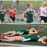 Top: Redmonds Chloe Connolly (2) and teammate Lili Hargreaves (3) dash toward the finish line in the 3,200 meters at districts. Hargreaves took third in 11:10.83 and Connolly finished sixth in 11:11.74. Both times were PRs. Below: Connolly, left, and Hargreaves catch their breath after running the 3,200. Andy Nystrom / staff photos