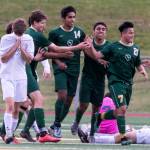 Redmond celebrates a goal by Angel Hernandez (right) with Snohomishs Eli Esterly dejected in the quarterfinals Friday night at Veterans Memorial Stadiums in Snohomish on May 18. (Kevin Clark / The Herald)