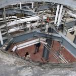 Jason Gorski and Keri Tawney can be seen through holes in ceiling in at the site of a planned three-story tower for DeLille Cellars at the old Redhook brewery in Woodinville. Aaron Kunkler/Staff photo