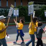 Nurse Amber Palermo, a member UFCW 21, takes video of picketers and their supporters outside at Providence Regional Medical Center Everett on Wednesday. (Andy Bronson / The Herald)