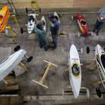 Parents and kids prep soap box derby cars outside the barn. (Andy Bronson / The Herald)