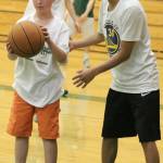 Redmond High player Malakai James, right, shows Ethan Gormley the ropes at last weeks camp. Andy Nystrom / staff photo