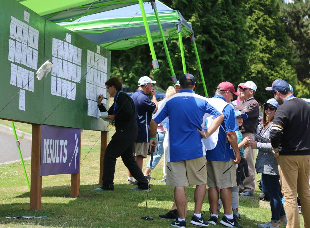 People gather around the results board. Andy Nystrom / staff photo