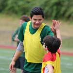 Redmond High varsity player Ricardo Escalante high fives Andres Turcato at this weeks Junior Mustangs Boys Soccer Camp. Andy Nystrom / staff photo