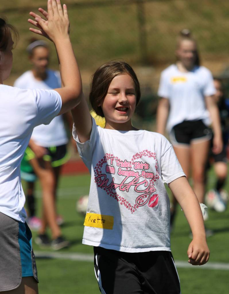 Camper Yvette Williams gives a high five after scoring a goal. Andy Nystrom / staff photo