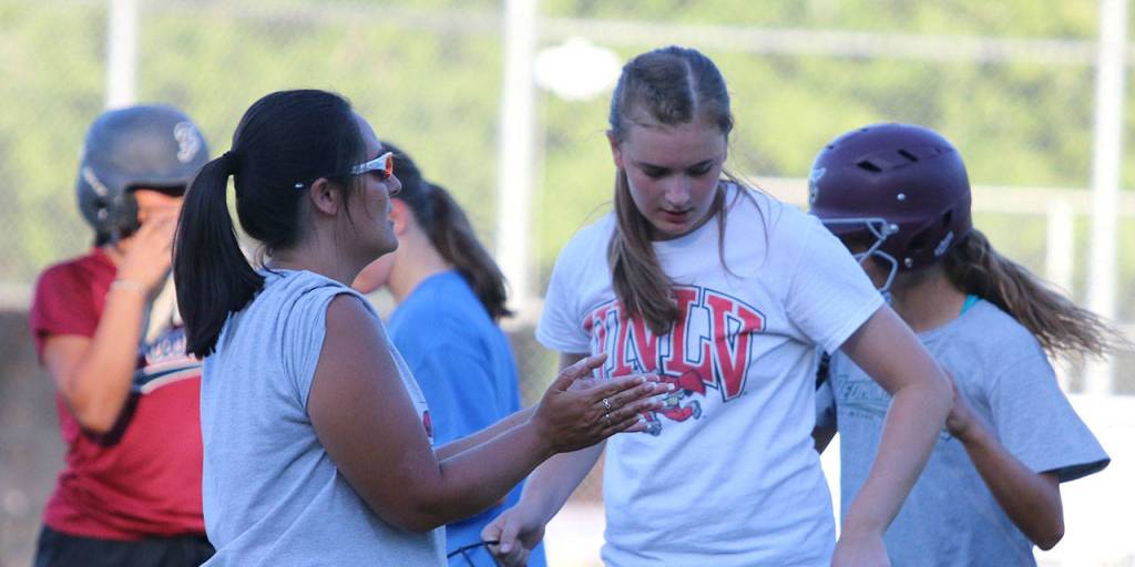 Manager Cheryl Johnson, second from left, cheers her team on during practice. Andy Nystrom / staff photo