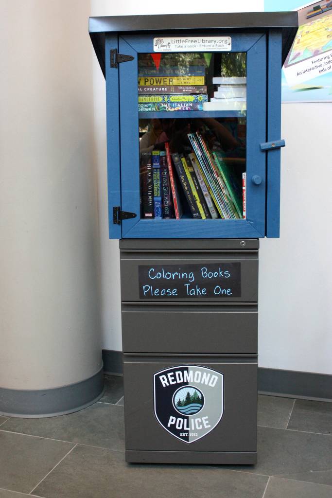 Redmond Police Departments Little Free Library sits in the middle of the Redmond Community Center. Anyone can leave a book and take a book from the small wooden box. Kailan Manandic, Redmond Reporter