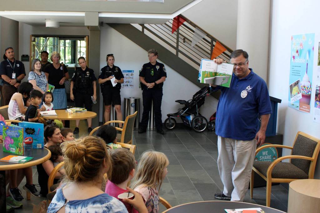 Redmond Mayor John Marchione reads Hop on Pop, a Dr. Seuss book, to kick off the Little Free Library opening. Kailan Manandic, Redmond Reporter