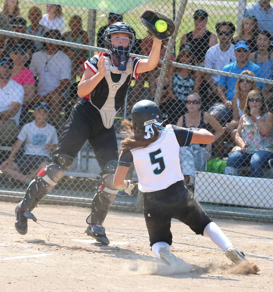 Kimora Johnson slides safely into home.