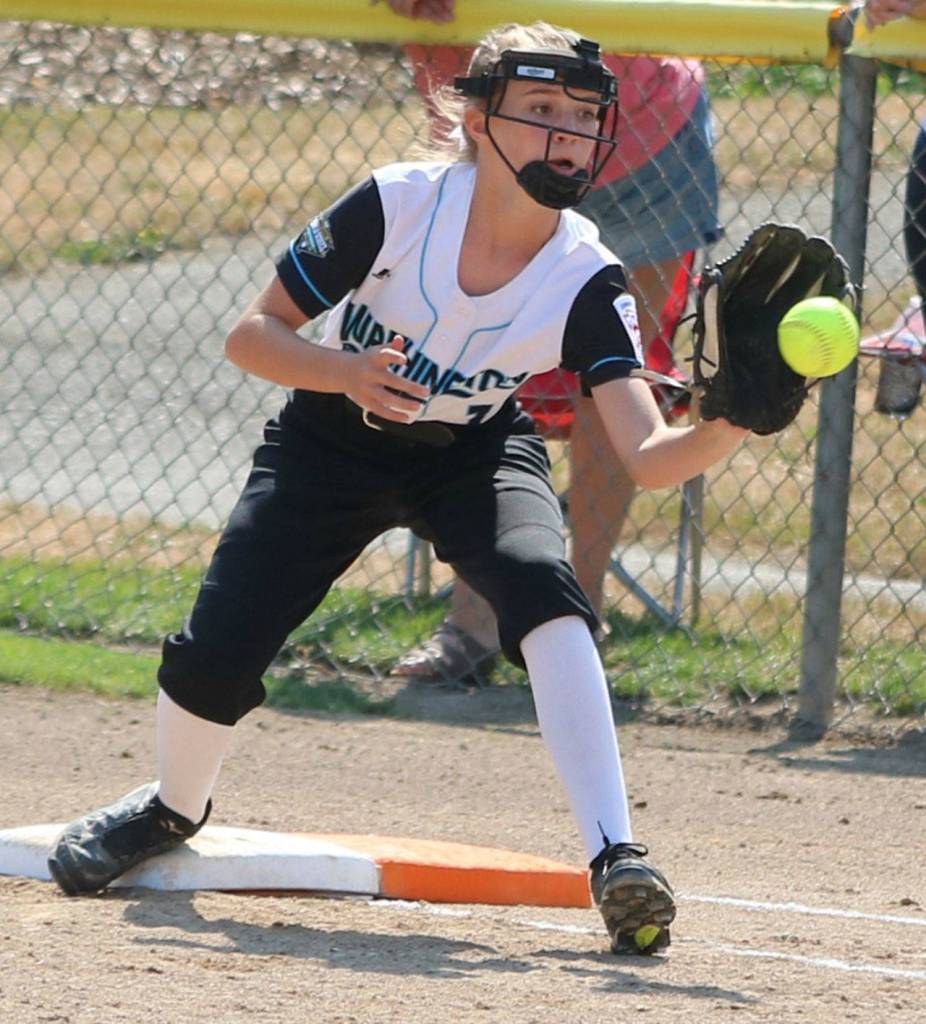 Sundis Cole makes a putout at first base.