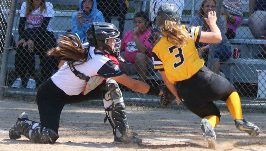 Kimora Johnson tags out a runner at home.
