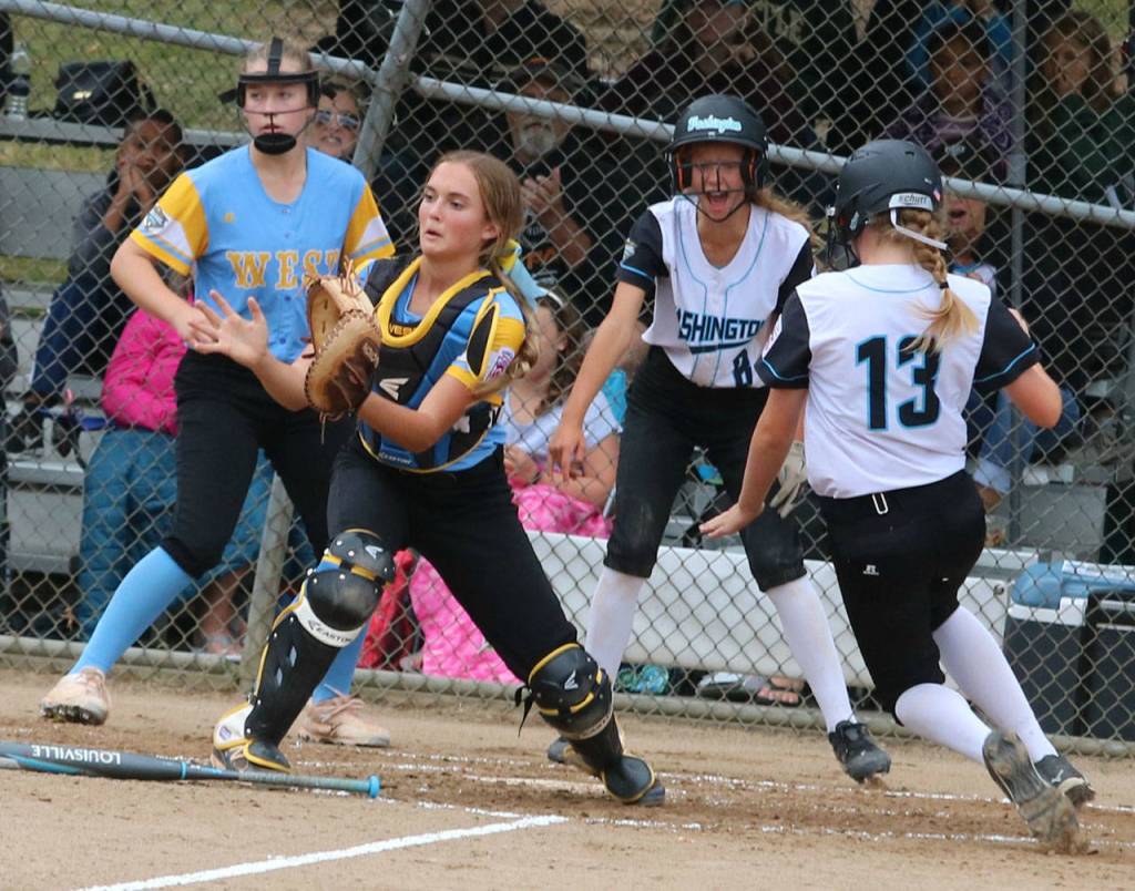 Ella Claus scores on Natalia Faragos double while teammate Karli Kostoff cheers her on.