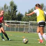 Juniors Sydney Trzupek, left, and Sofiya Mitchell compete during practice. Andy Nystrom / staff photo