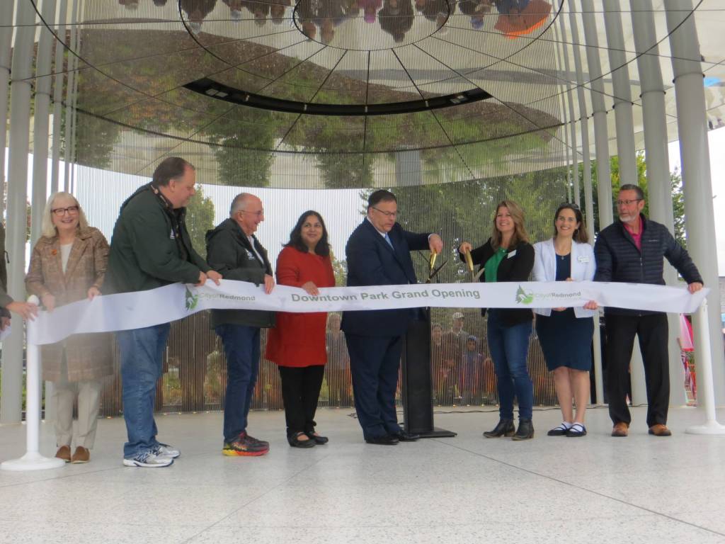 Redmond City Council members and state Rep. Joan McBride cut the ribbon signifying Downtown Parks grand opening. Samantha Pak/staff photo
