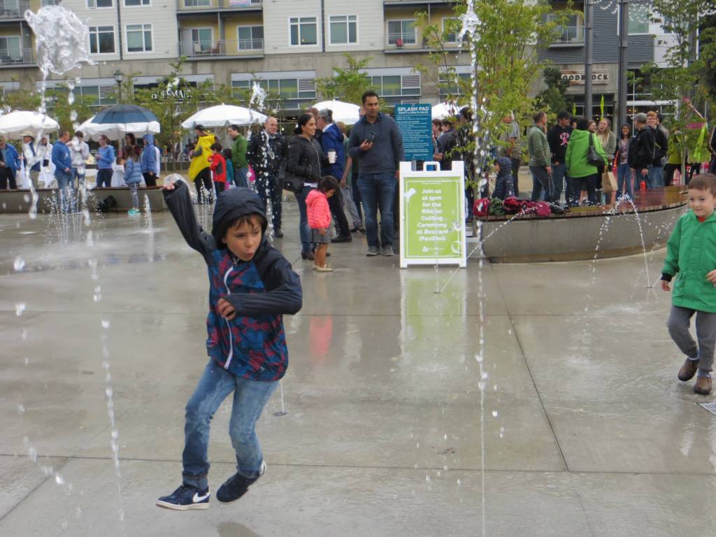 A young boy weaves through the water fountains in Downtown Parks splash pad. Samantha Pak/staff photo