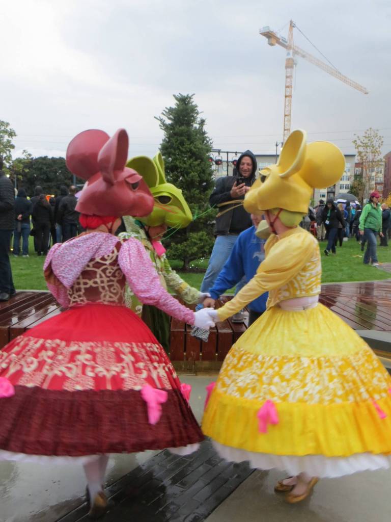 A few of Lucia Neares mice pull a park goer into their circle of merriment. Samantha Pak/staff photo