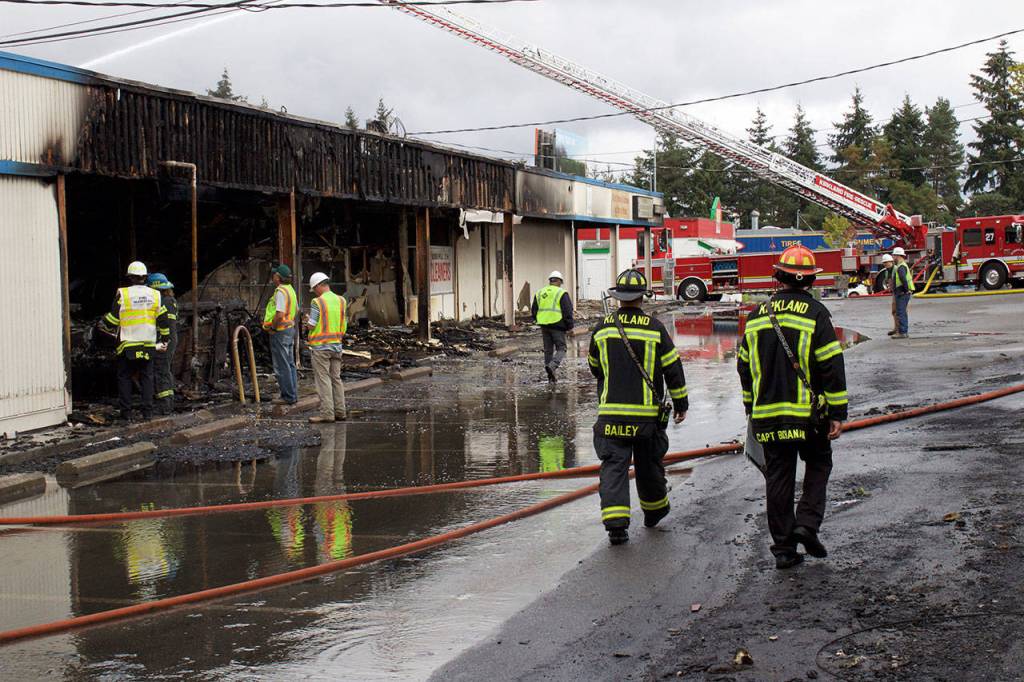 Kirkland firefighter patrol the aftermath of the Rose Hill Village fire, watching for hot spots and investigating the cause. Kailan Manandic/staff photo
