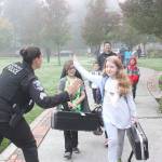 A Redmond police officer high fives Horace Mann Elementary students on International Walk to school Day on Oct. 10. Thousands of schools across the country, including 10 Redmond schools, participated in the 22nd Annual Walk to School Day. Redmond students helped reduce neighborhood traffic congestion and local air pollution by walking, biking, carpooling or riding the school bus. International Walk to School Day is facilitated as a part of Redmonds SchoolPool program. The program works with schools to provide education on safety topics and events like Walk and Bike to School Days to encourage healthy behaviors for students and also rewards local students and schools for reducing the number of drive-alone trips to school. Stephanie Quiroz/staff photo.