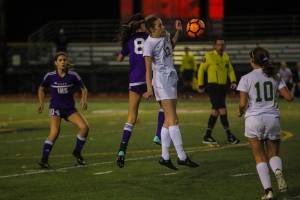 Redmond defender Taylor Pisan (No. 17) battles for possession of the ball against Issaquah in the Wes-King 4A girls district soccer tournament championship game. Issaquah outscored Redmond 4-2 in penalty kicks in an overtime shootout, earning a 1-0 victory on Nov. 1 at Gary Moore Stadium in Issaquah. Photo courtesy of Don Borin/Stop Action Photography