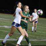 Redmonds Aspen Sullivan (9), right, goes for the ball against a Bellarmine Prep player. Andy Nystrom / staff photo